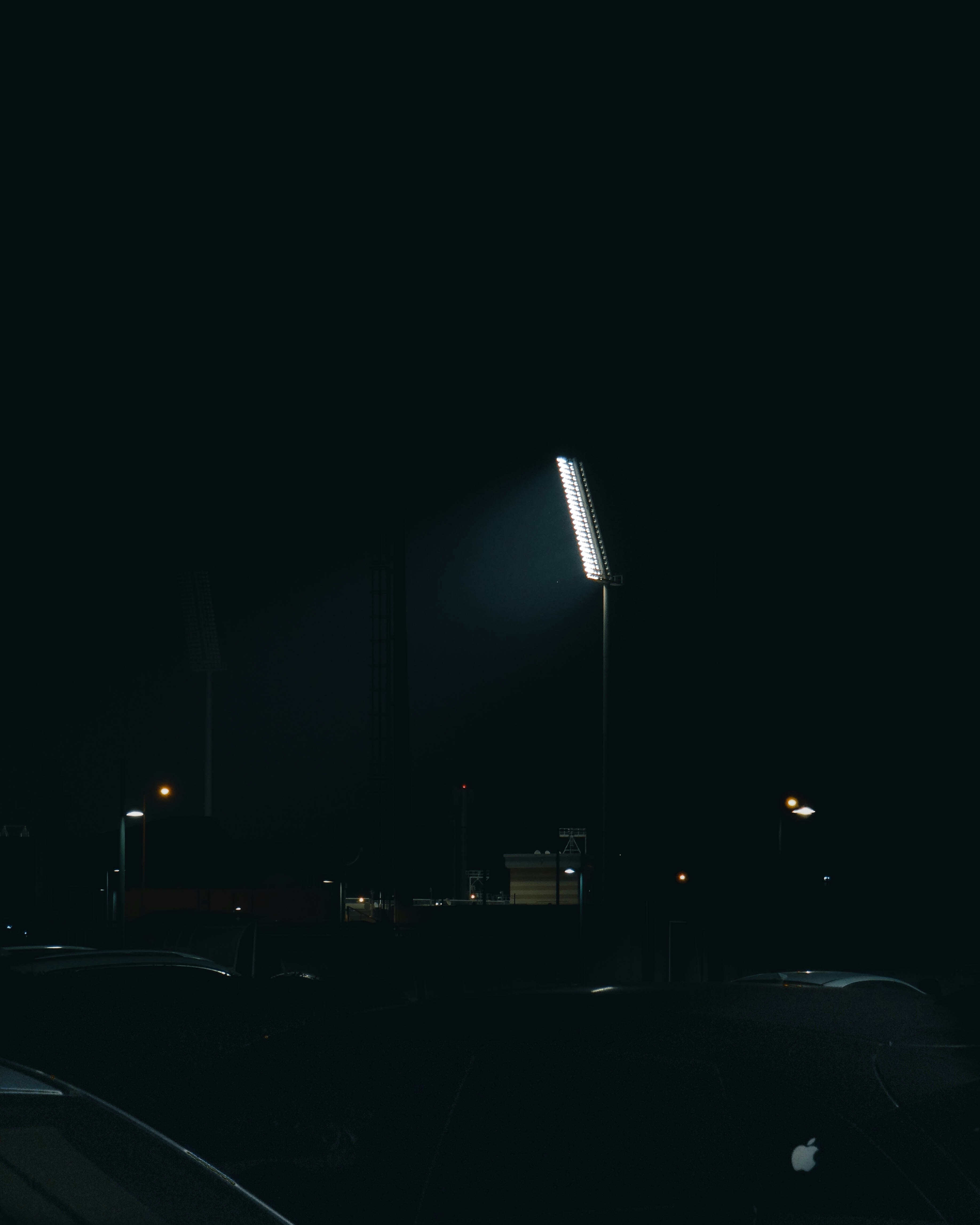 a street light shines bright in the dark