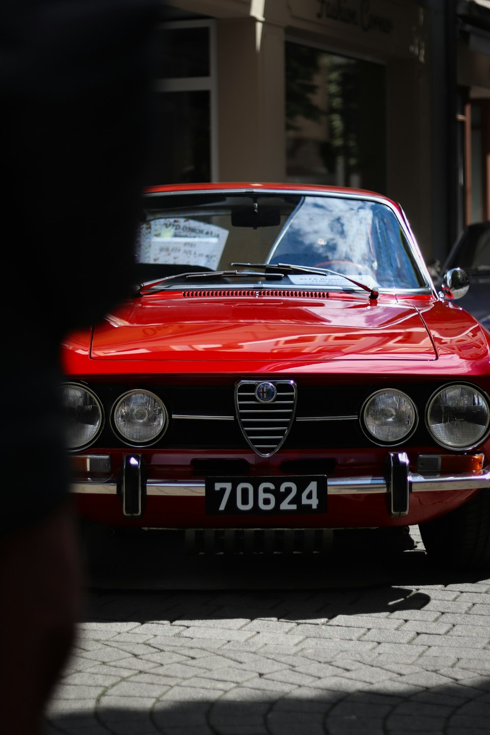 a red car parked on the side of the road