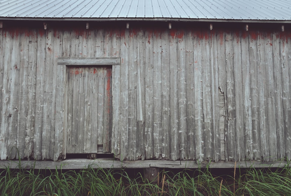 an old weathered barn with a wooden door