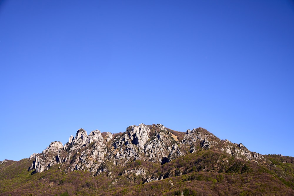 a mountain with a clear blue sky in the background