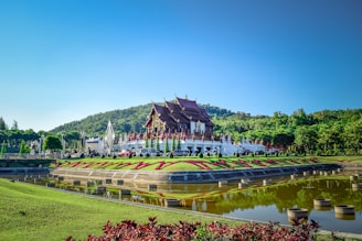 a large building sitting on top of a lush green field