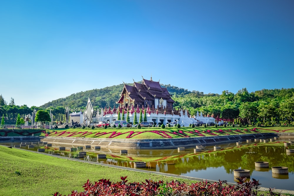 a large building sitting on top of a lush green field