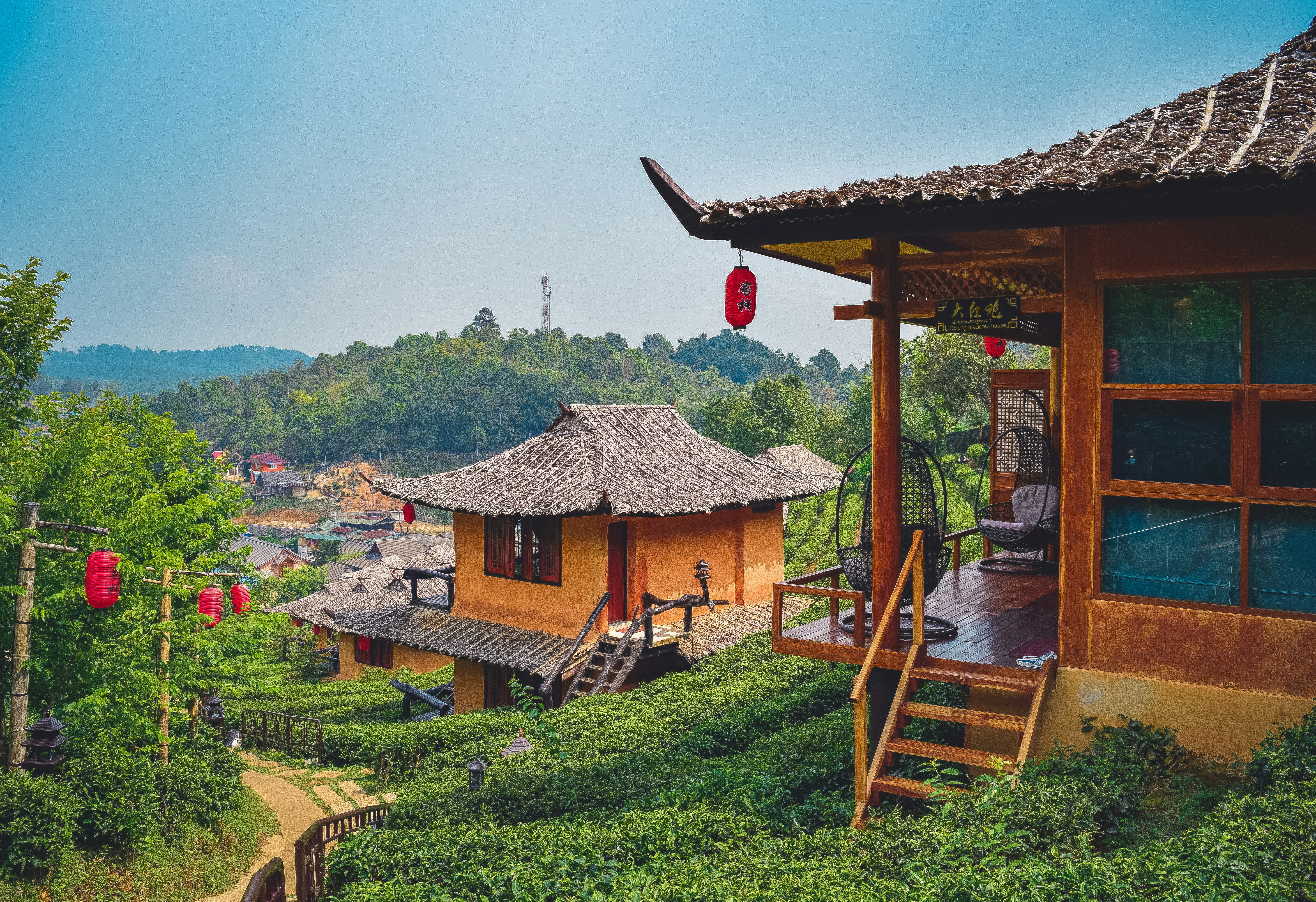 a house with a thatched roof on a hill, 
