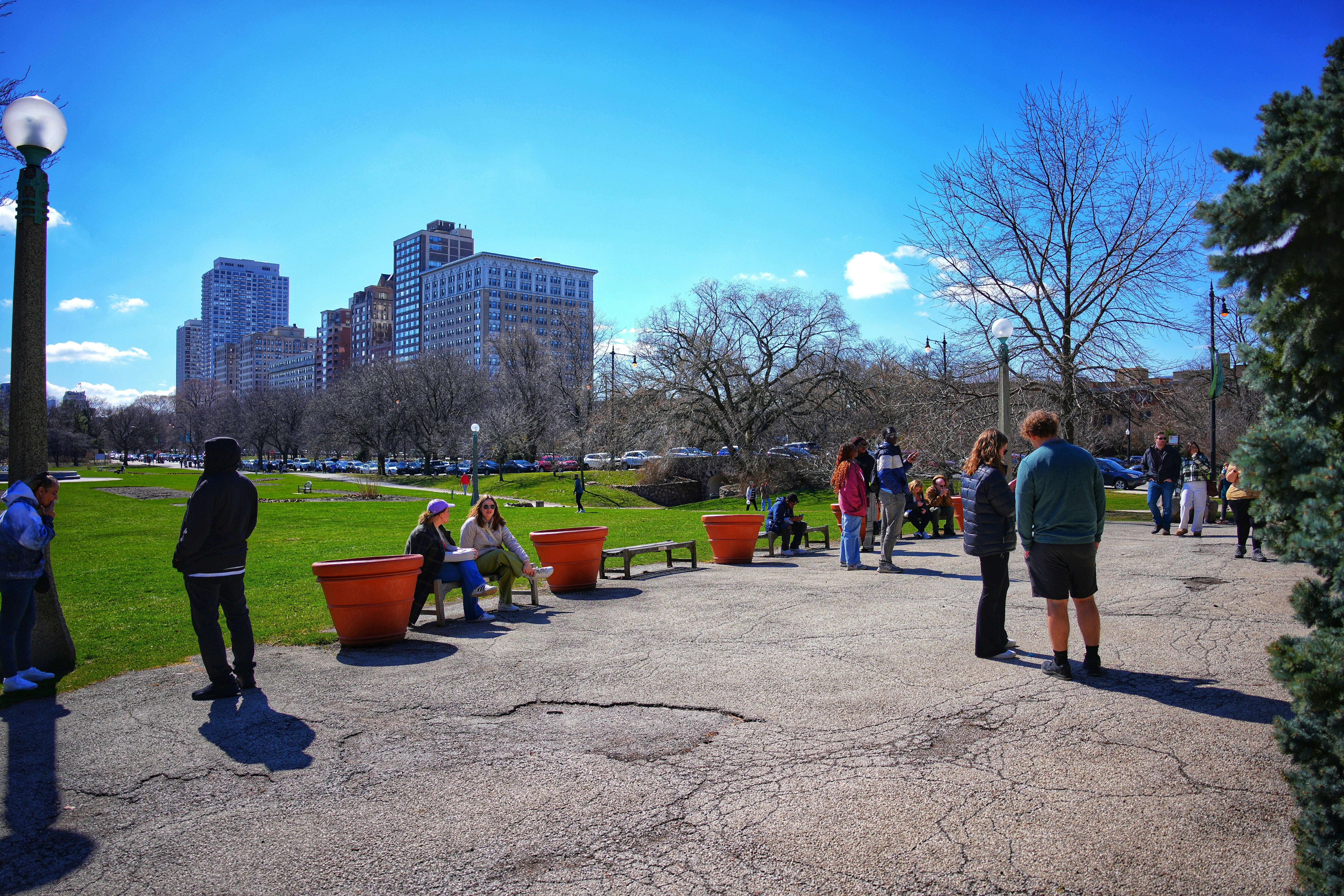 a group of people sitting on a bench in a park