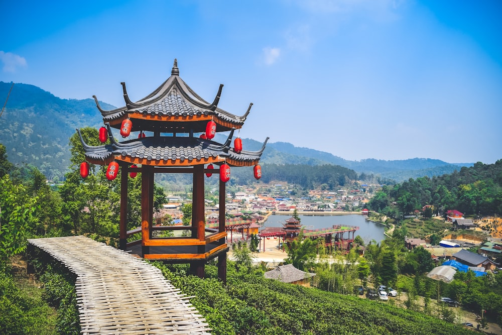 a pagoda on top of a hill overlooking a lake