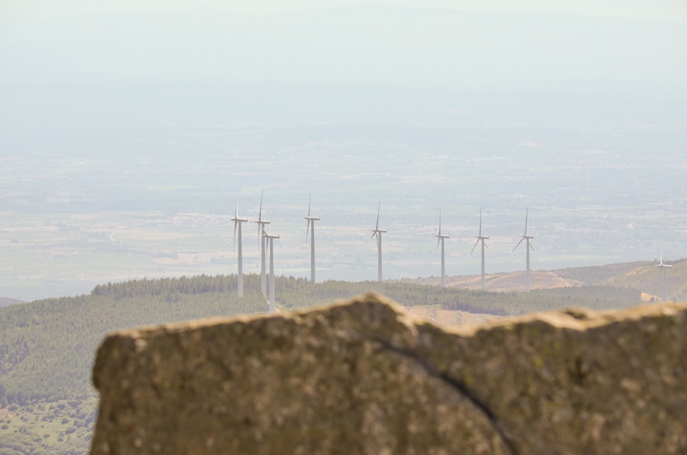 a group of wind turbines on a hill