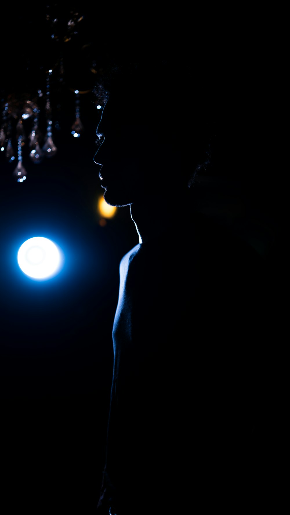 a person standing in the dark with a light on