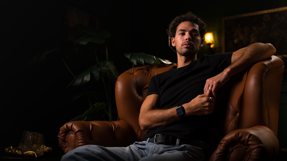 a man sitting in a chair with his arms crossed