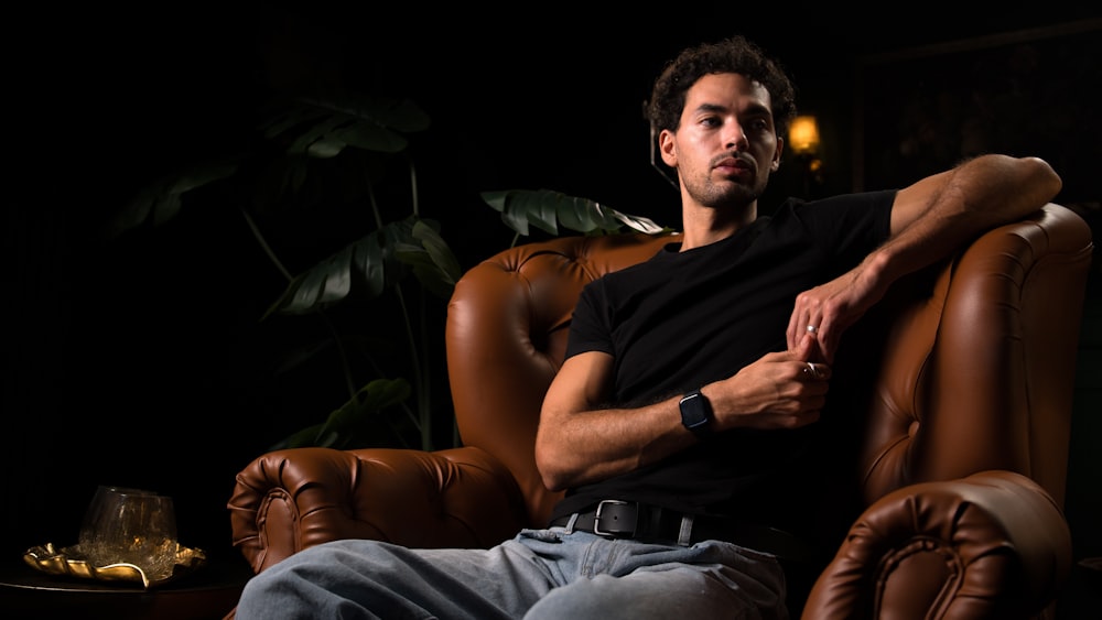 a man sitting in a chair with his arms crossed