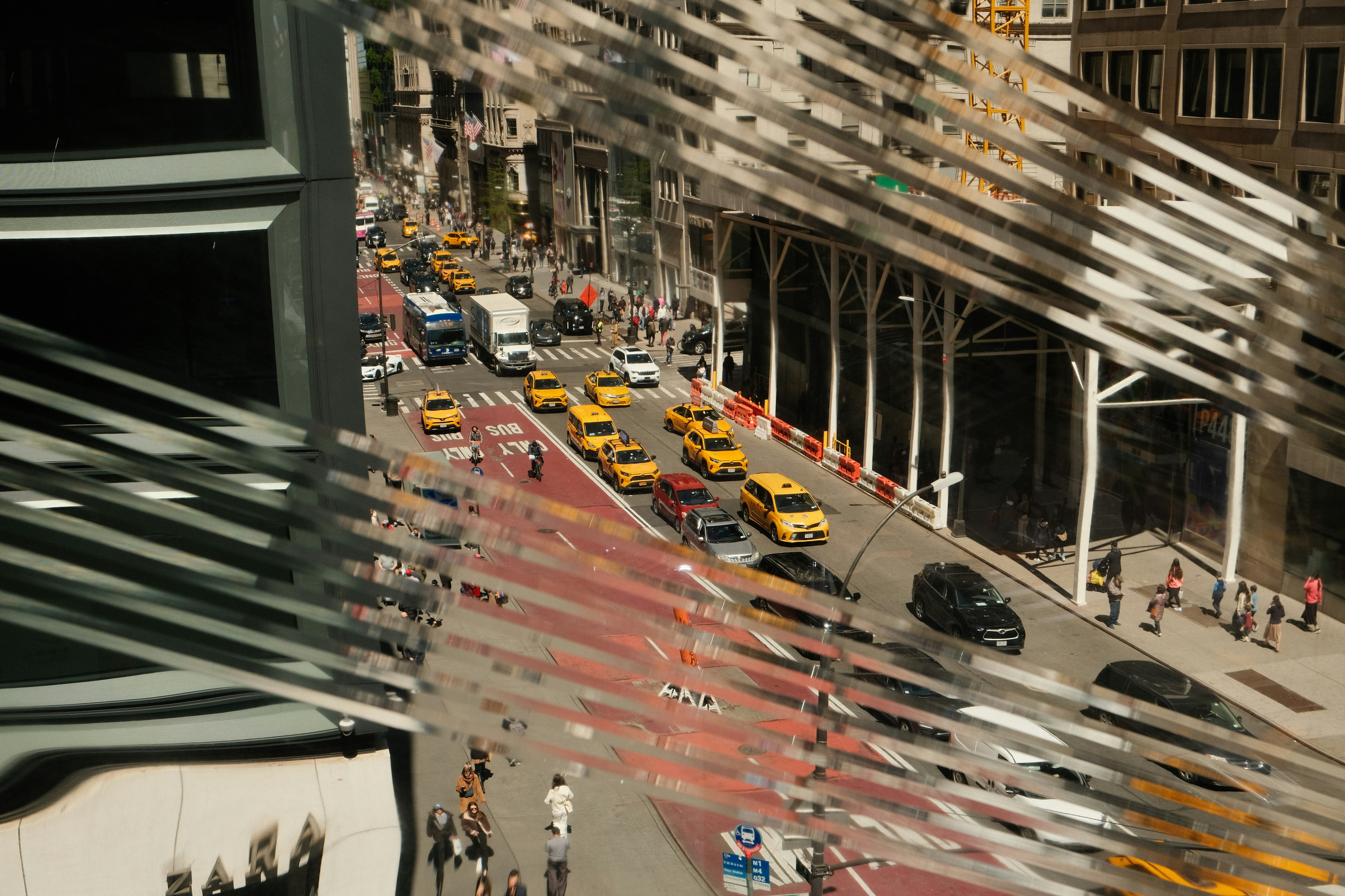 A city street filled with lots of traffic next to tall buildings photo ...