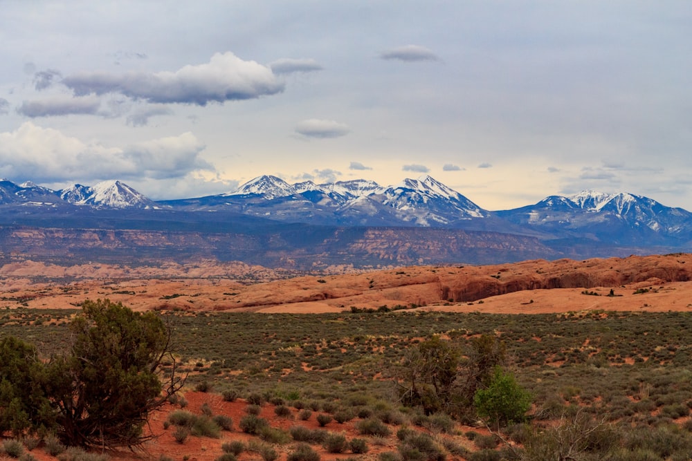 a mountain range with snow capped mountains in the distance