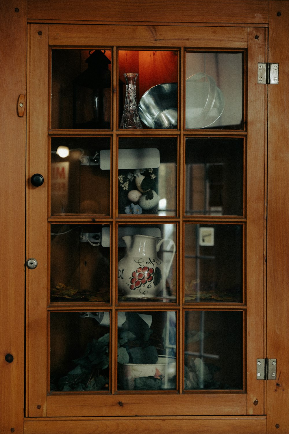 a wooden cabinet filled with dishes and dishes