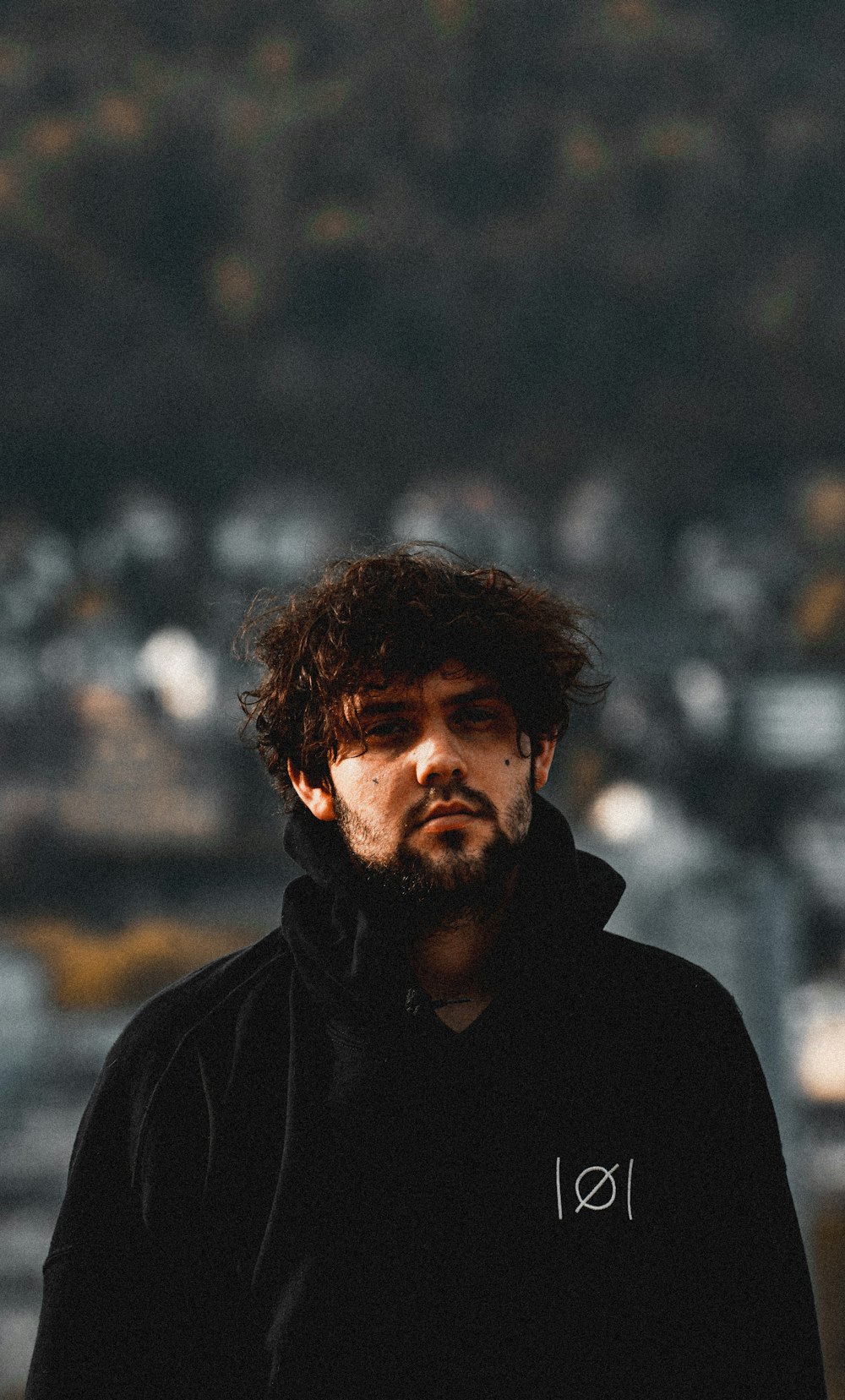 a man with a beard wearing a black hoodie