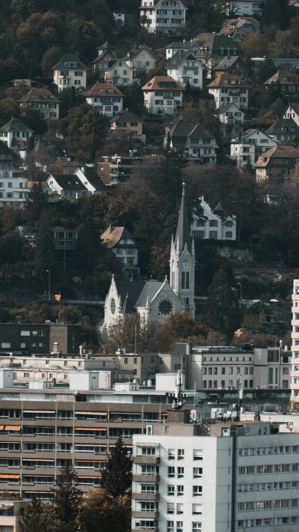 a view of a city with a church steeple in the background