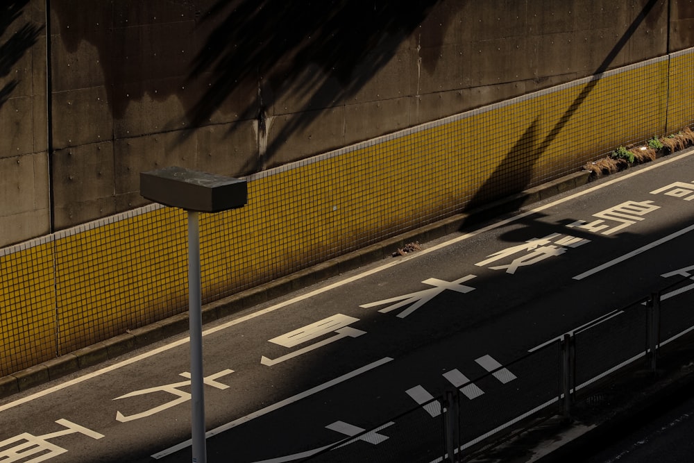 an overhead view of a street with a yellow wall