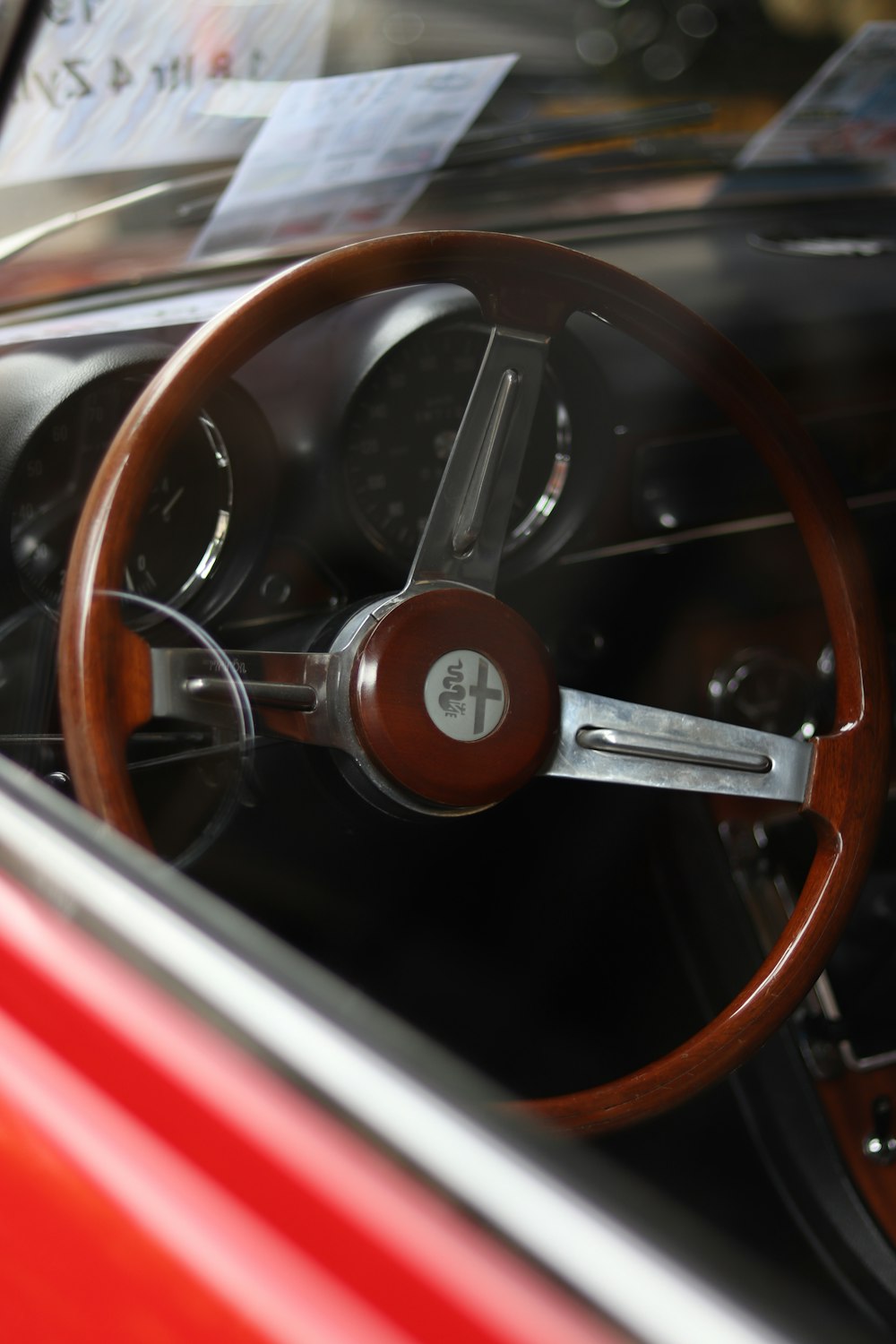 a steering wheel and dashboard of a classic car