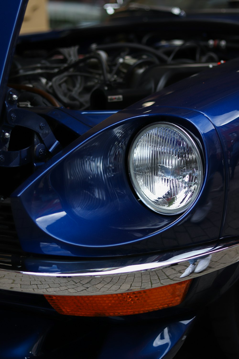 a close up of a car's headlight and engine