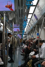 a group of people sitting on a train next to each other