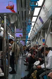 a group of people sitting on a train next to each other