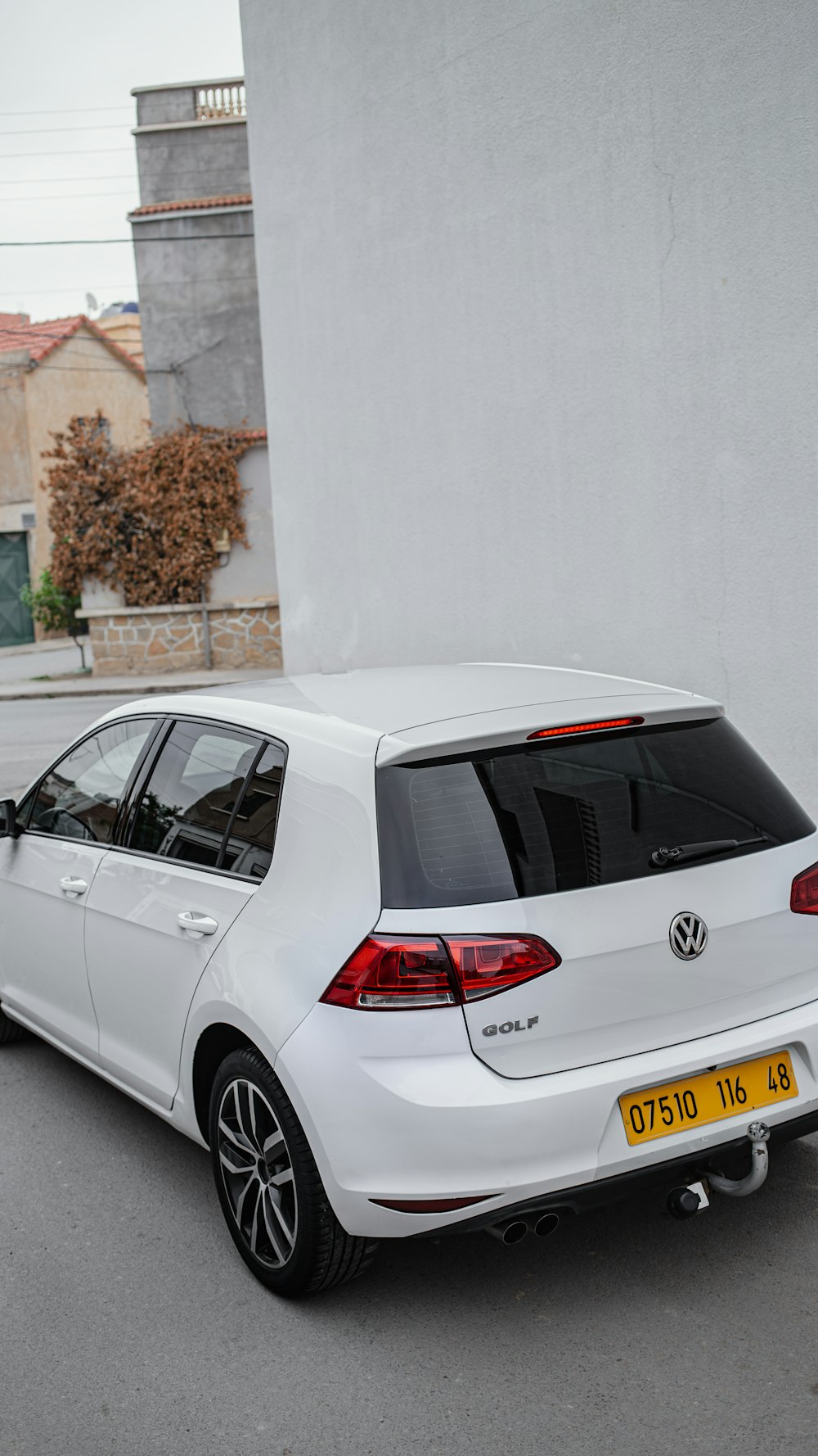 a white car parked in front of a building