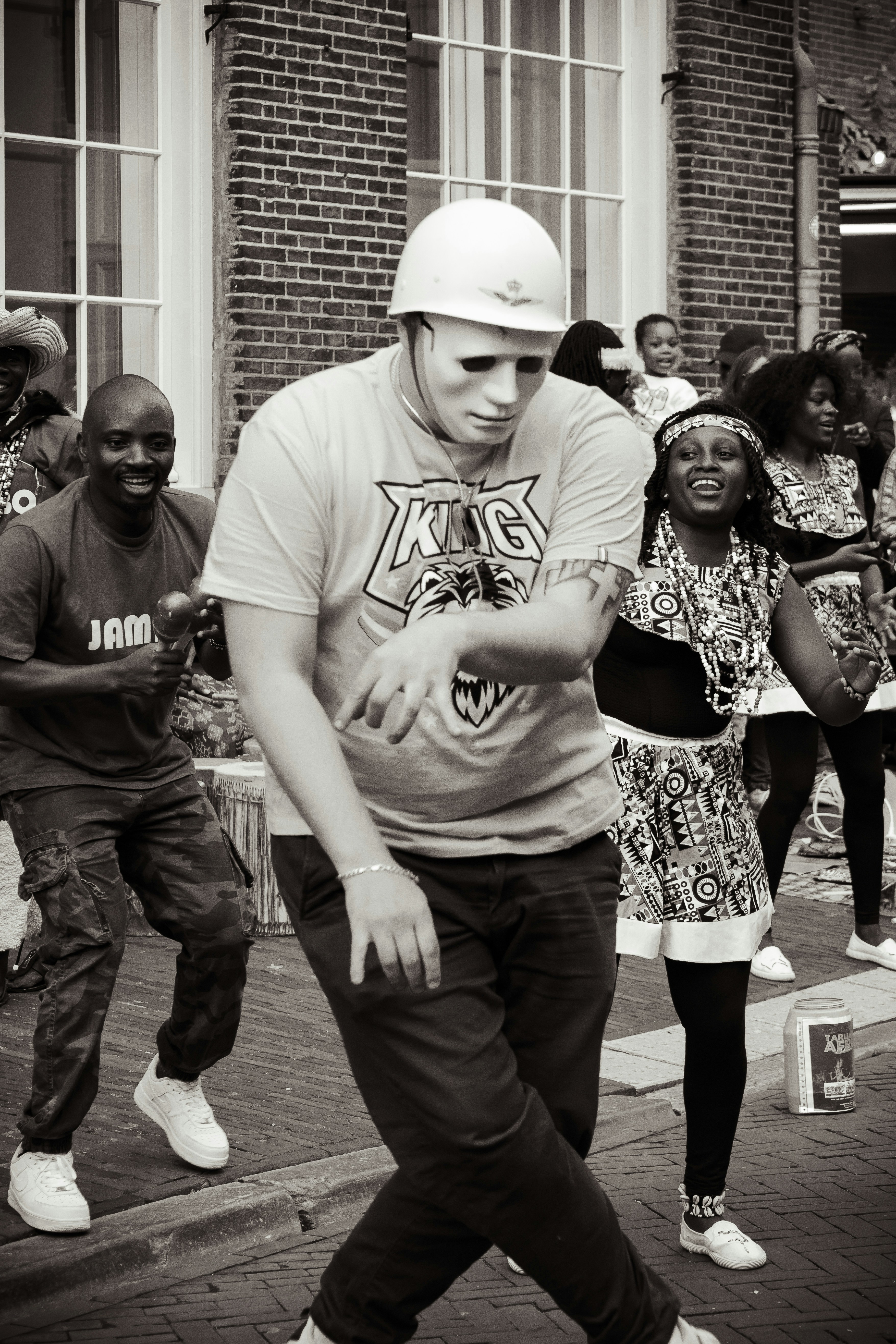 Outdoor block party with people dancing and celebrating in a neighborhood street