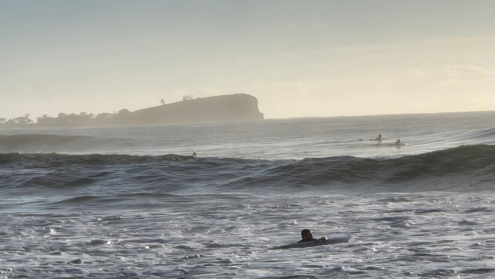 a person riding a surfboard on a wave in the ocean