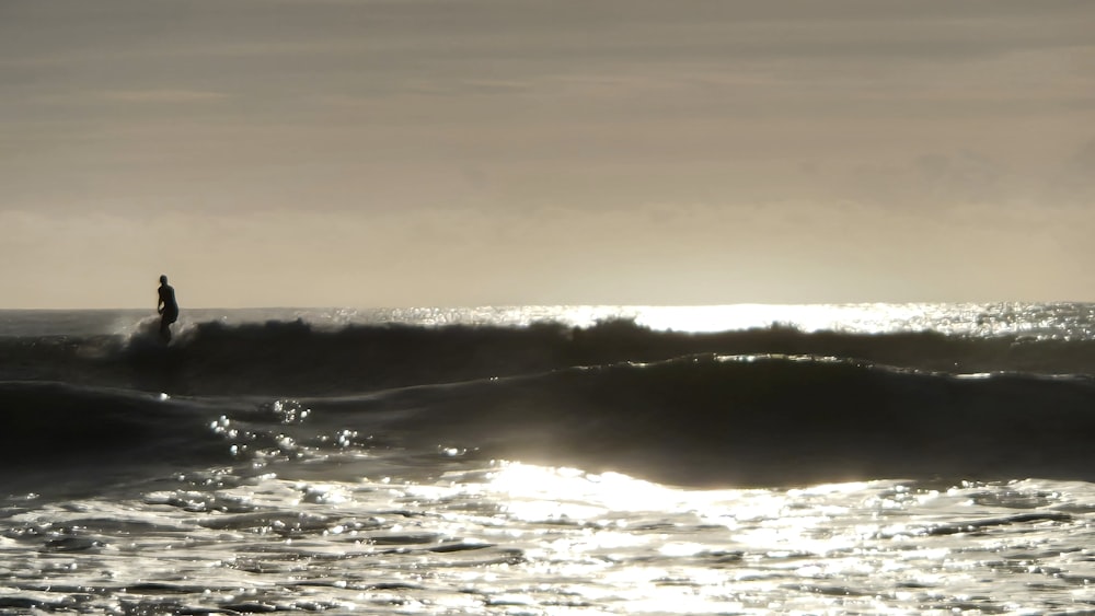 a person riding a wave on top of a surfboard