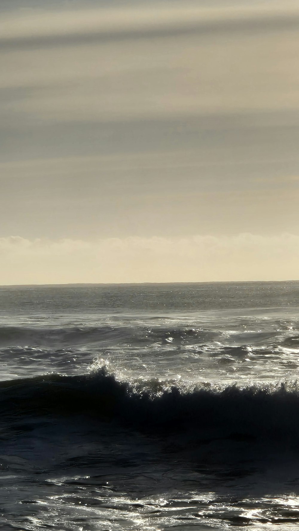 a person riding a surfboard on a wave in the ocean