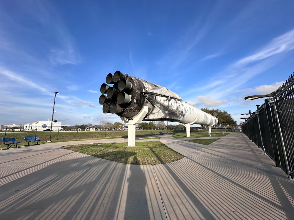 a large metal object sitting on top of a sidewalk