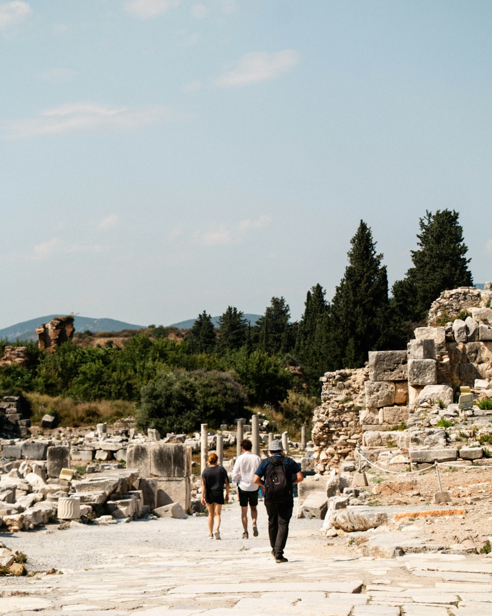 a group of people walking down a stone walkway