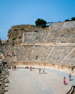 a group of people standing on top of a stone stage