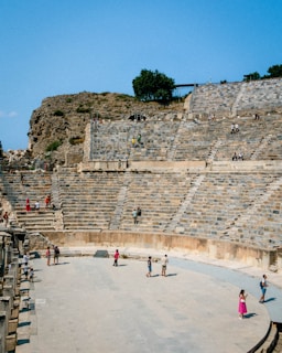 a group of people standing on top of a stone stage