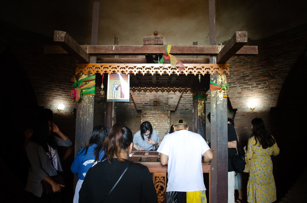 a group of people standing around a shrine