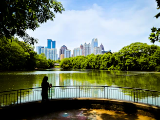 a person standing on a bridge over a river