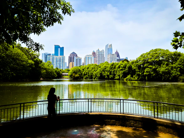 a person standing on a bridge over a river