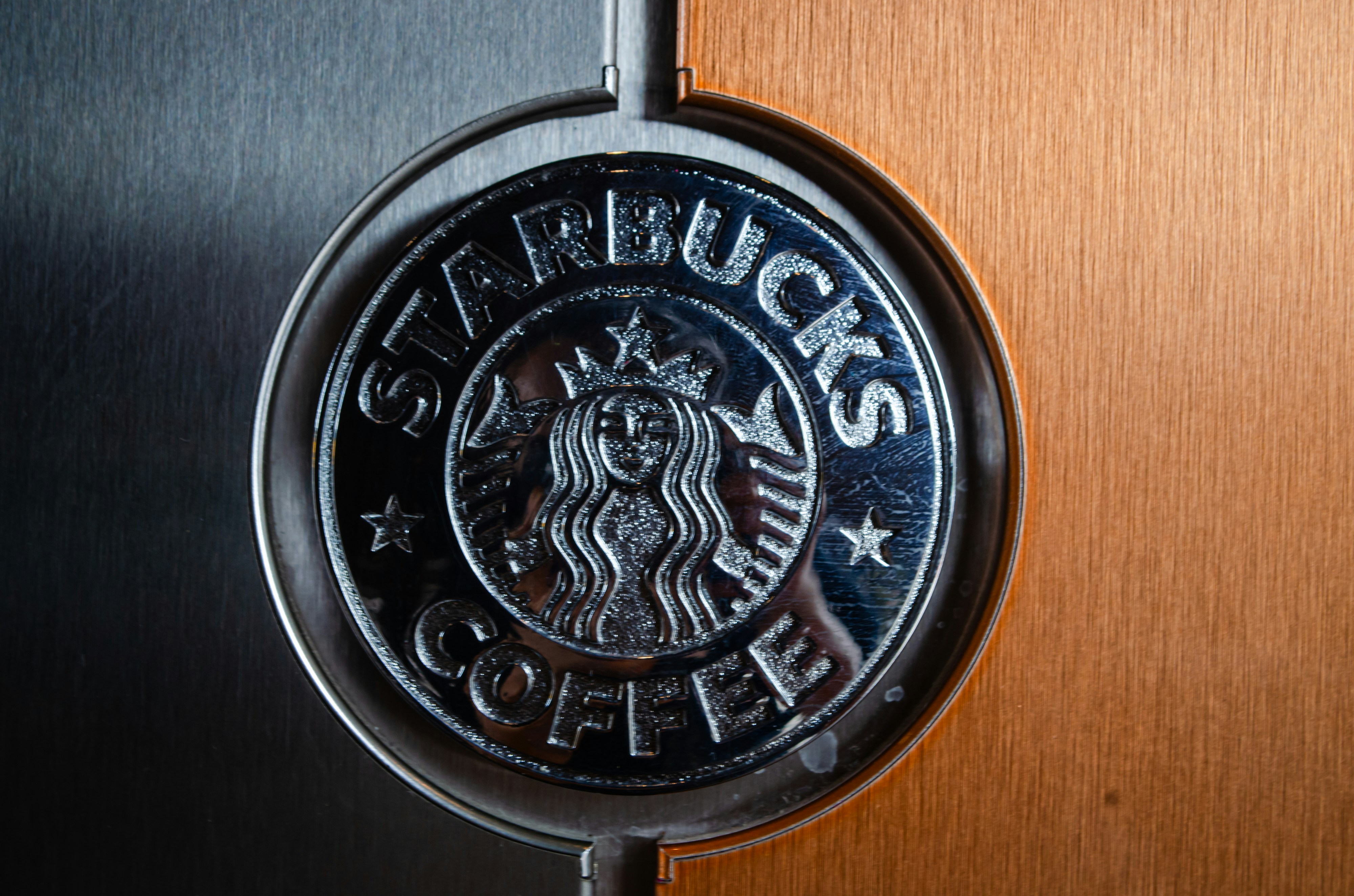 a close up of a starbucks logo on a door