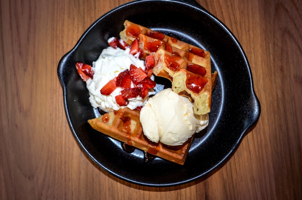 a waffle topped with strawberries and ice cream