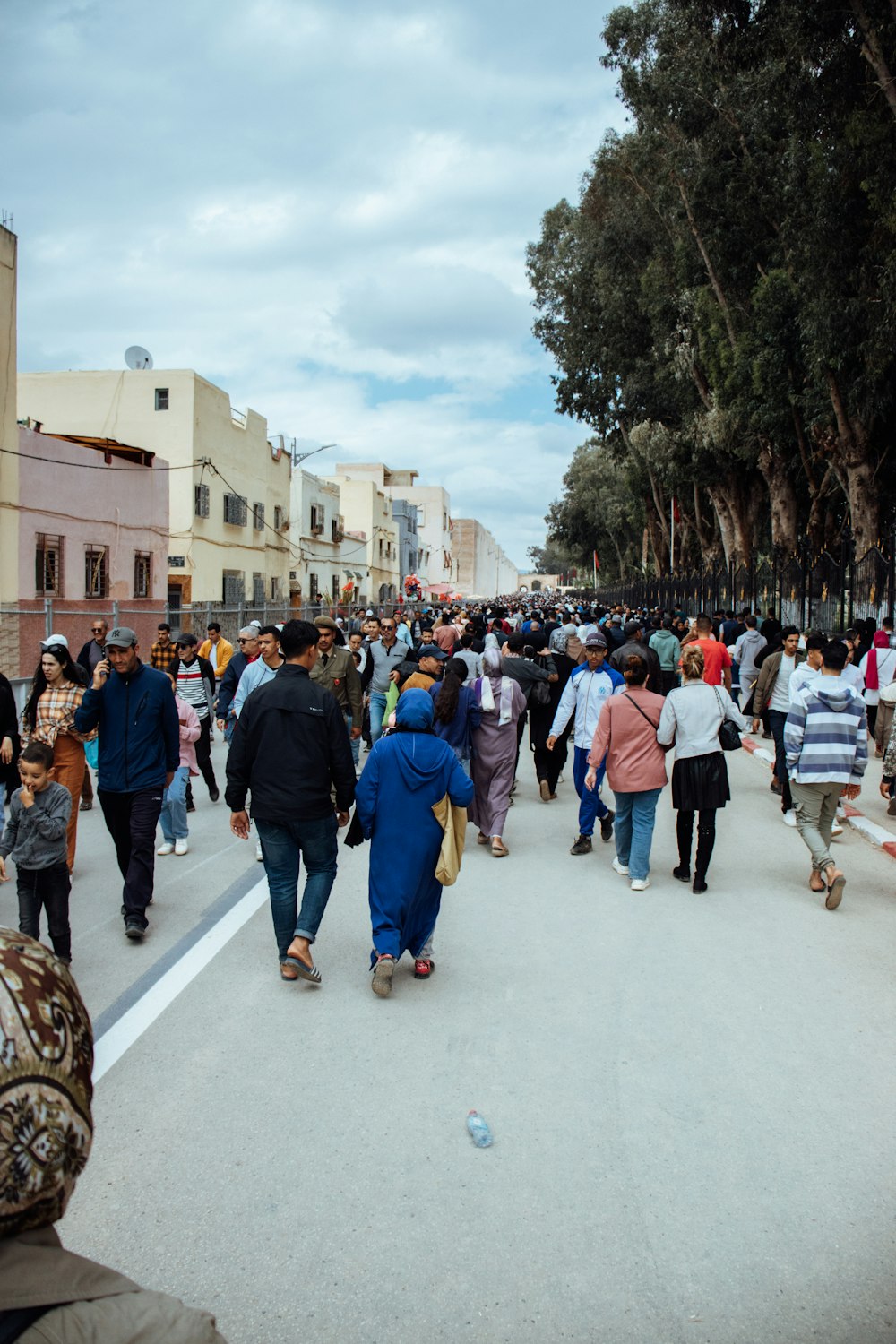 a crowd of people walking down a street