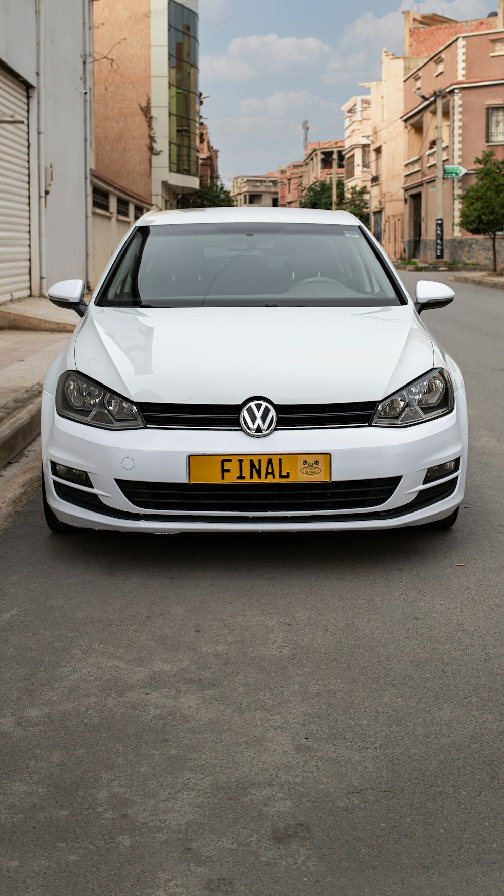 a white car parked on the side of the road