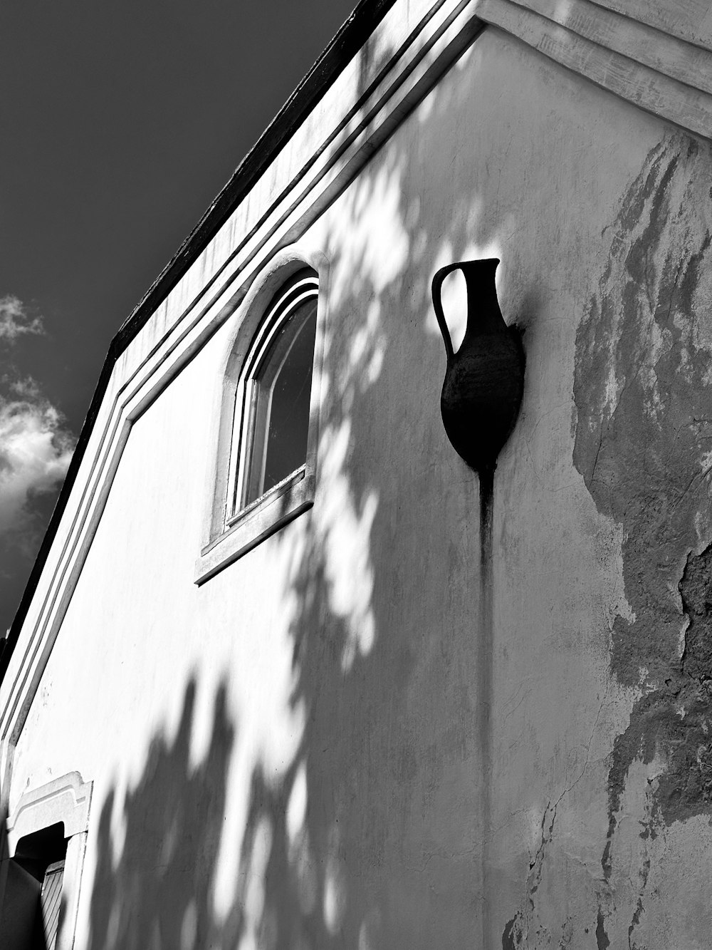 a black and white photo of a window on a building