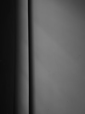 a black and white photo of a corner of a wall