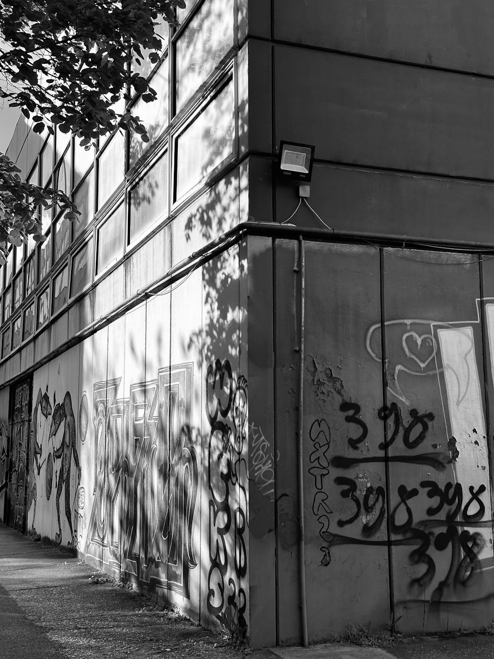 black and white photograph of a building with graffiti on it