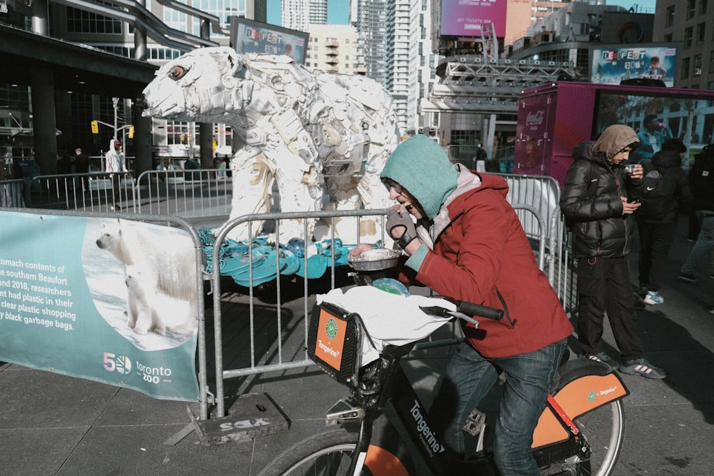 a person on a bike with a polar bear on the back