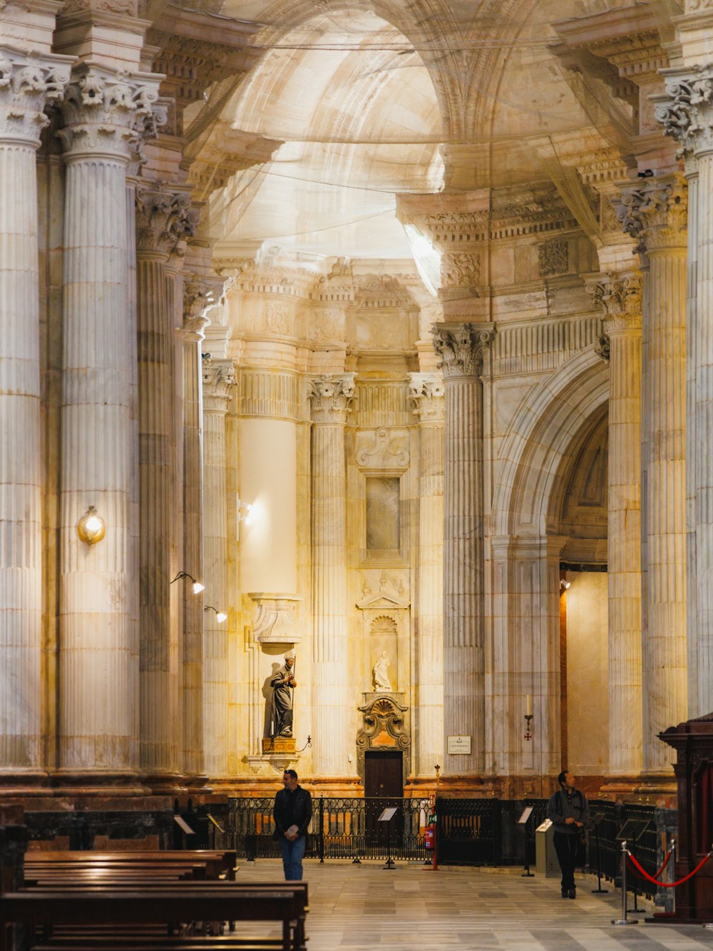 a person standing in a large room with columns