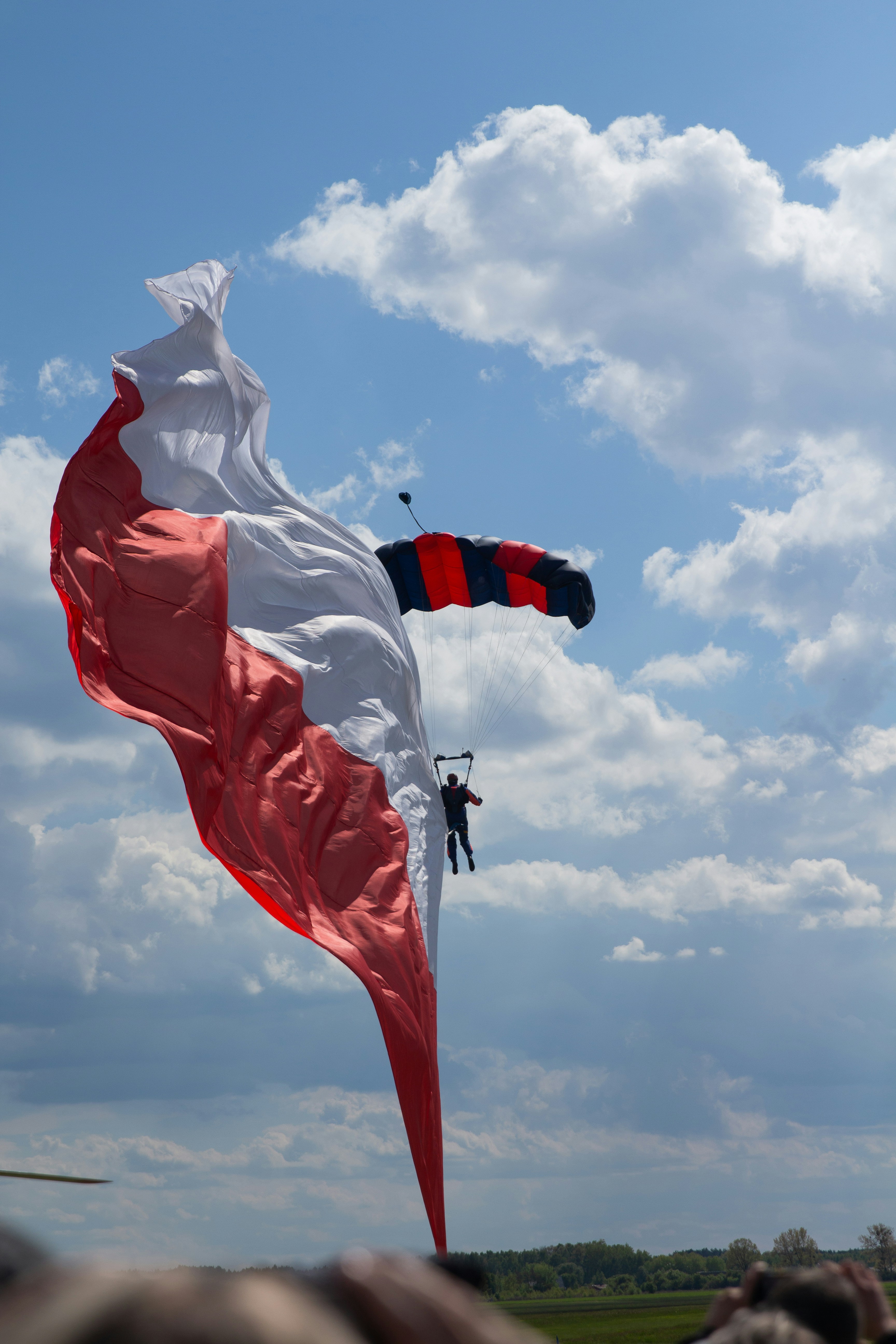 a person is flying a large kite in the sky