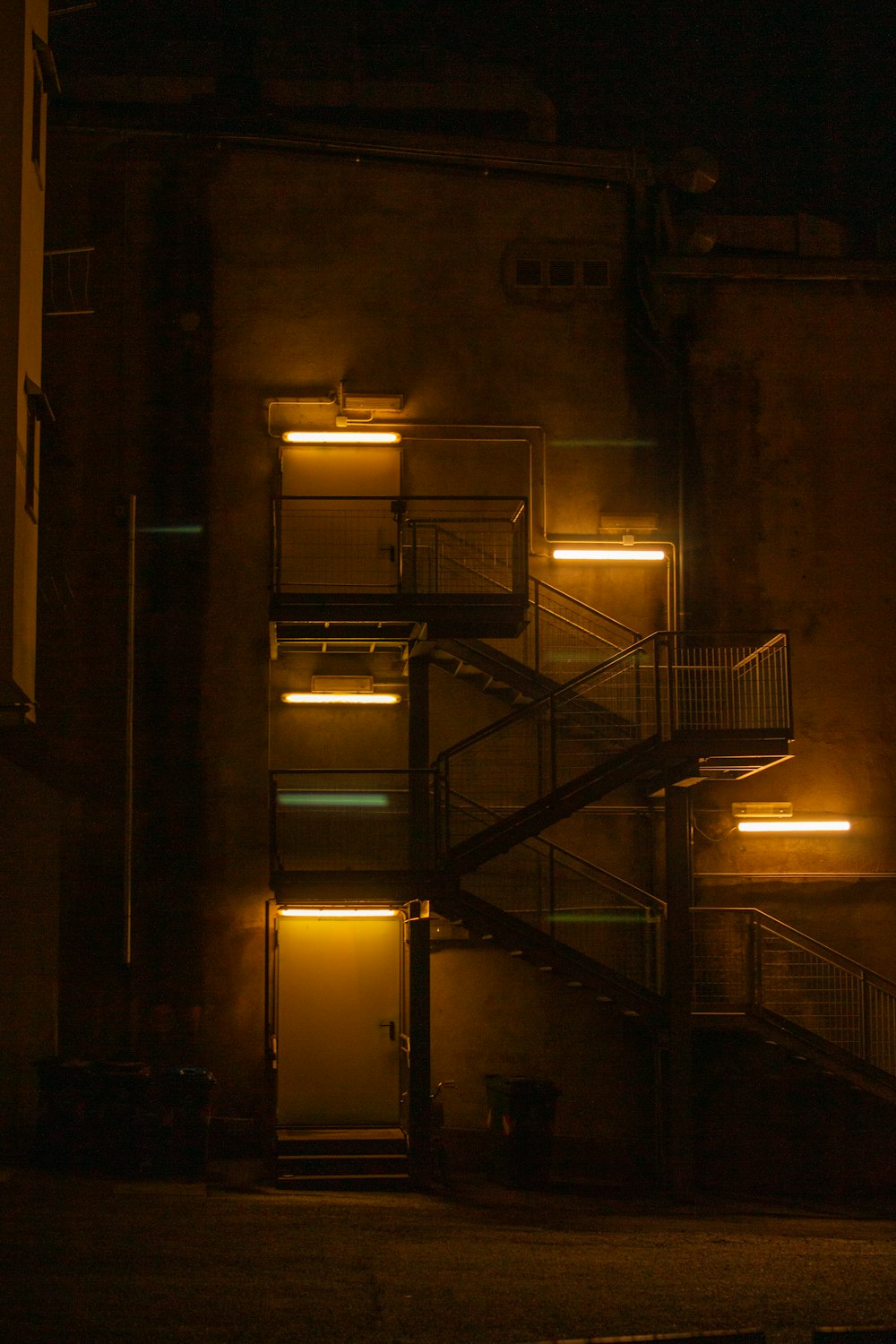 a fire escape is lit up at night