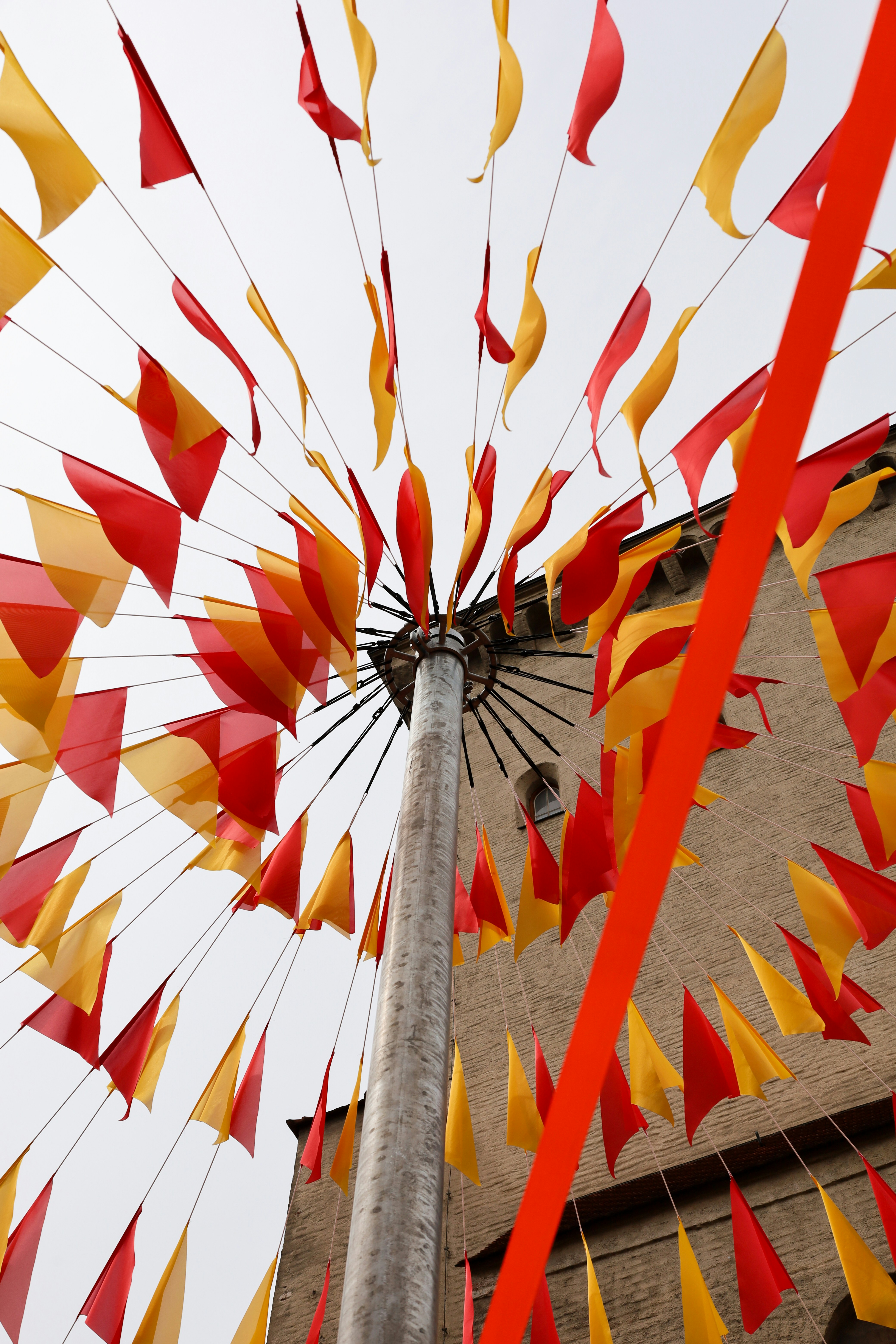 a pole that has some red and yellow flags on it