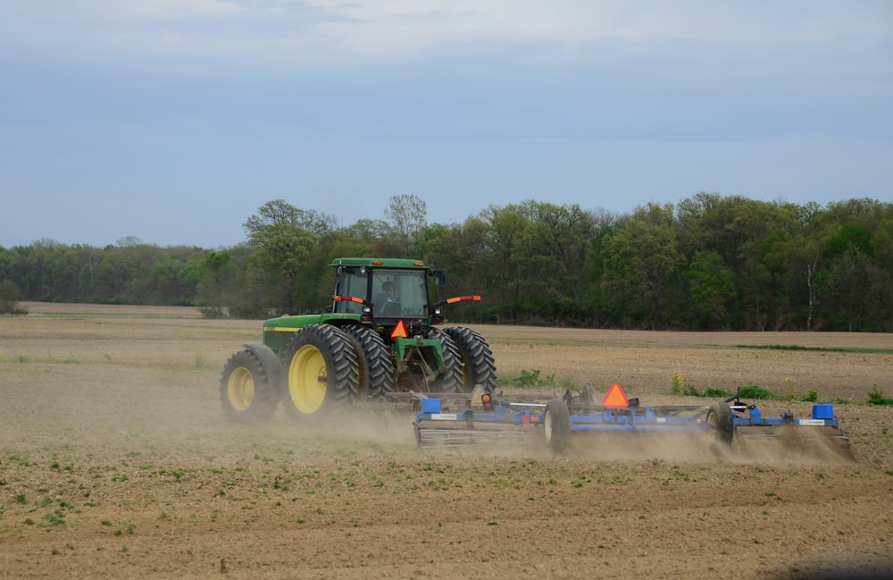 a tractor plowing a field with a plow