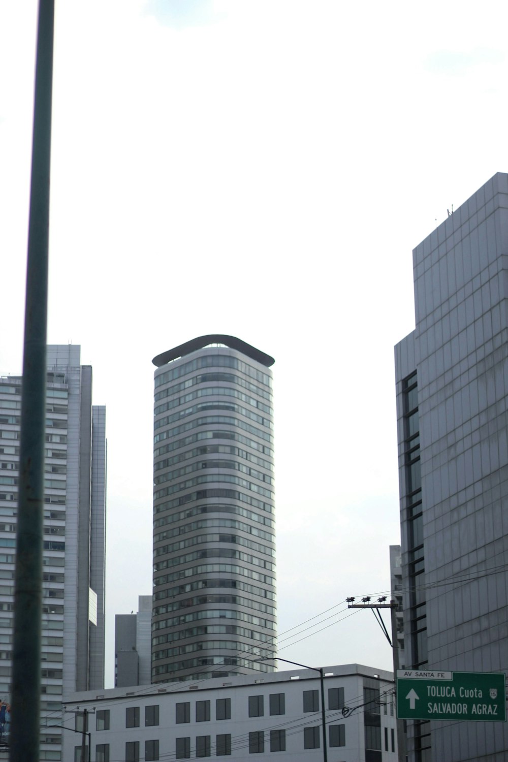 a city street with tall buildings in the background