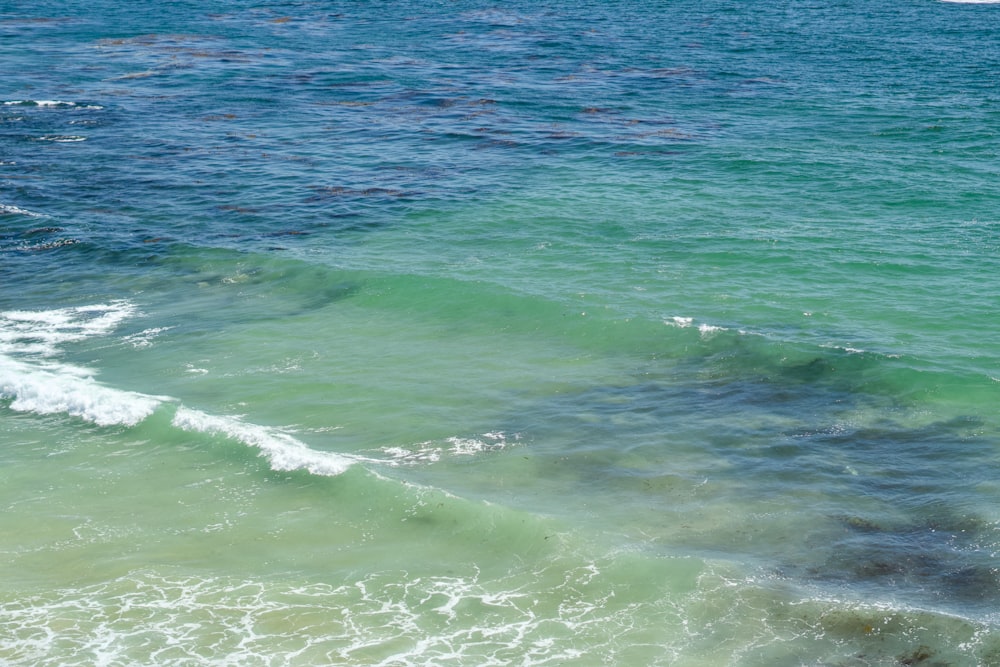 a man riding a surfboard on top of a wave in the ocean